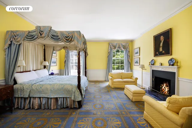 a living room with fireplace furniture and a large window