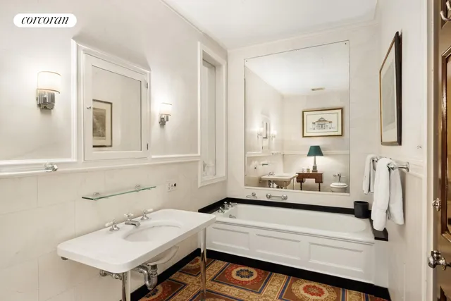 a bedroom with a bed a flat screen tv and a fireplace