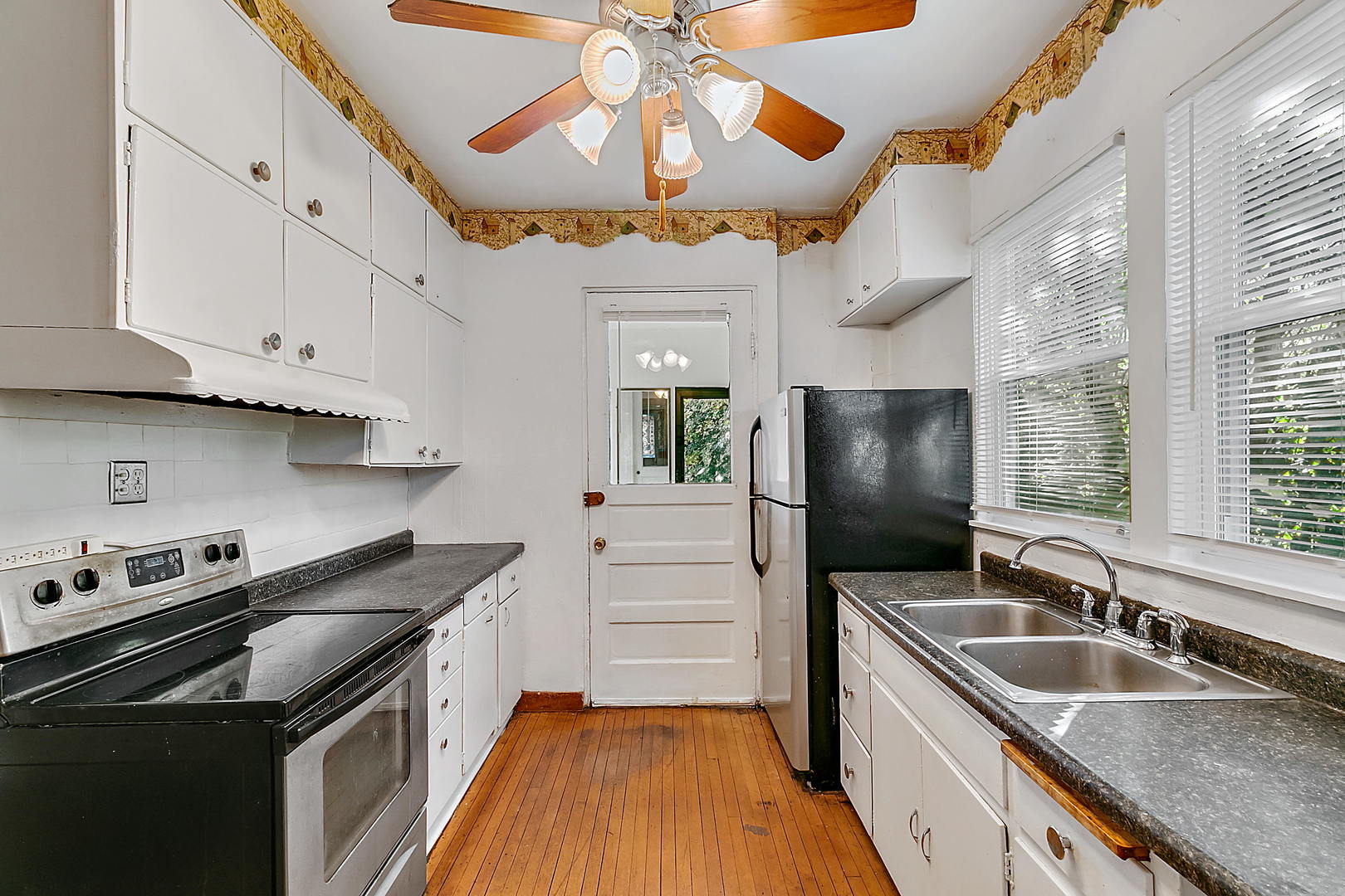 99 Pine Avenue Riverside, IL 60546 - Photo 14 of 31 a kitchen with stainless steel appliances granite countertop a sink a stove and a refrigerator