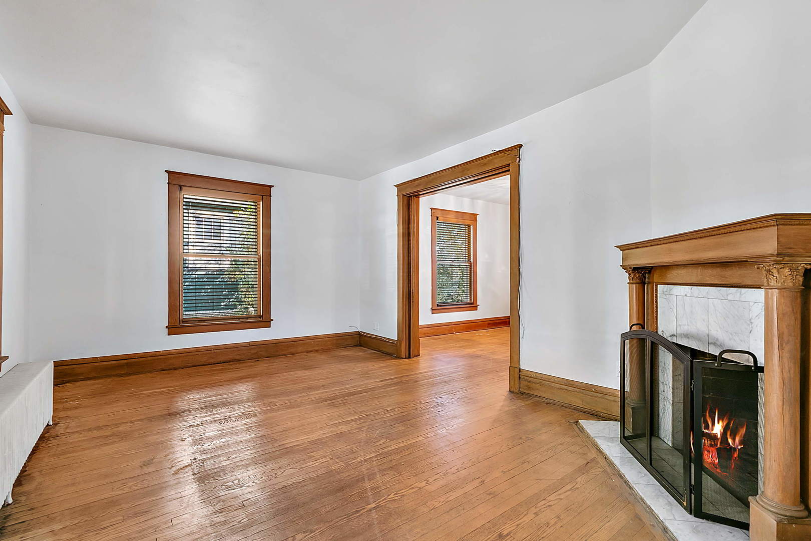 99 Pine Avenue Riverside, IL 60546 - Photo 5 of 31 a view of an empty room with wooden floor fireplace and a window