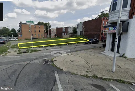 a view of a tennis ground with large trees
