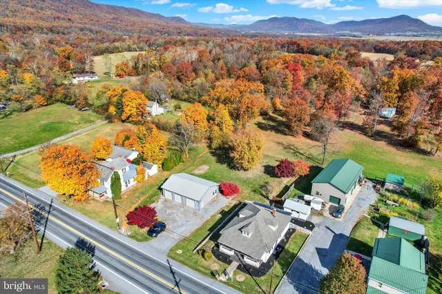 a living room with furniture wooden floor and a window