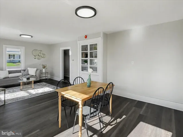 a kitchen with a sink cabinets and wooden floor