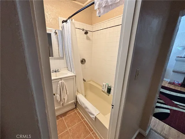a bathroom with a tub a sink and a shower