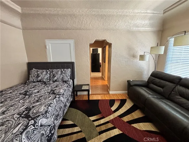 a living room with a couch and wooden floor