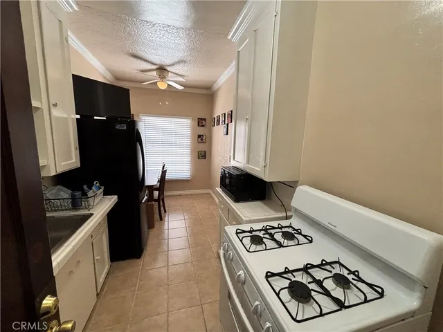 a kitchen with a stove a refrigerator and a sink