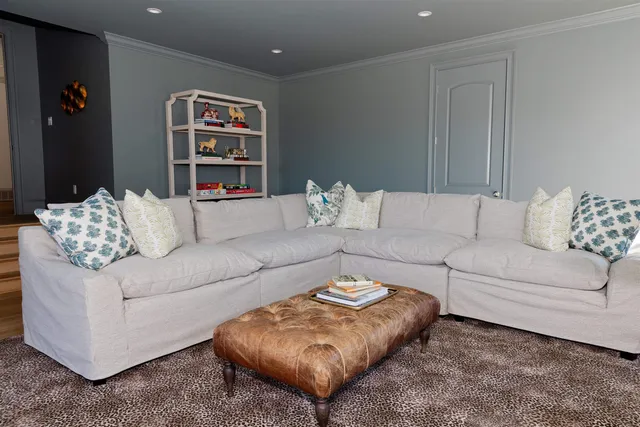 a living room with furniture and painting on the wall