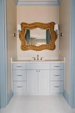 a bathroom with a sink mirror and vanity