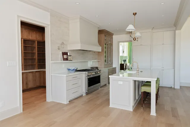 a kitchen with a stove a sink and a refrigerator