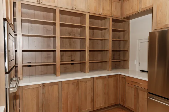 a kitchen with a white cabinets and a refrigerator