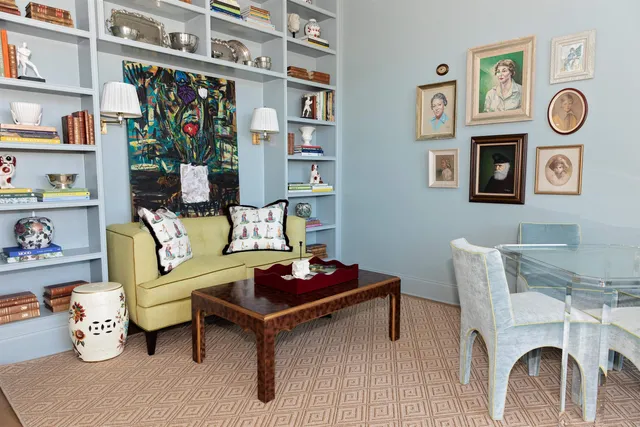 a living room with furniture and a clock