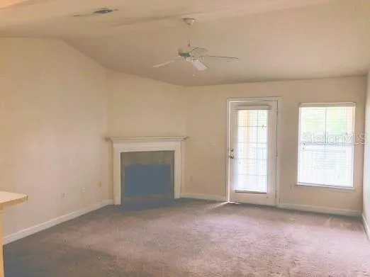 an empty room with windows and closet