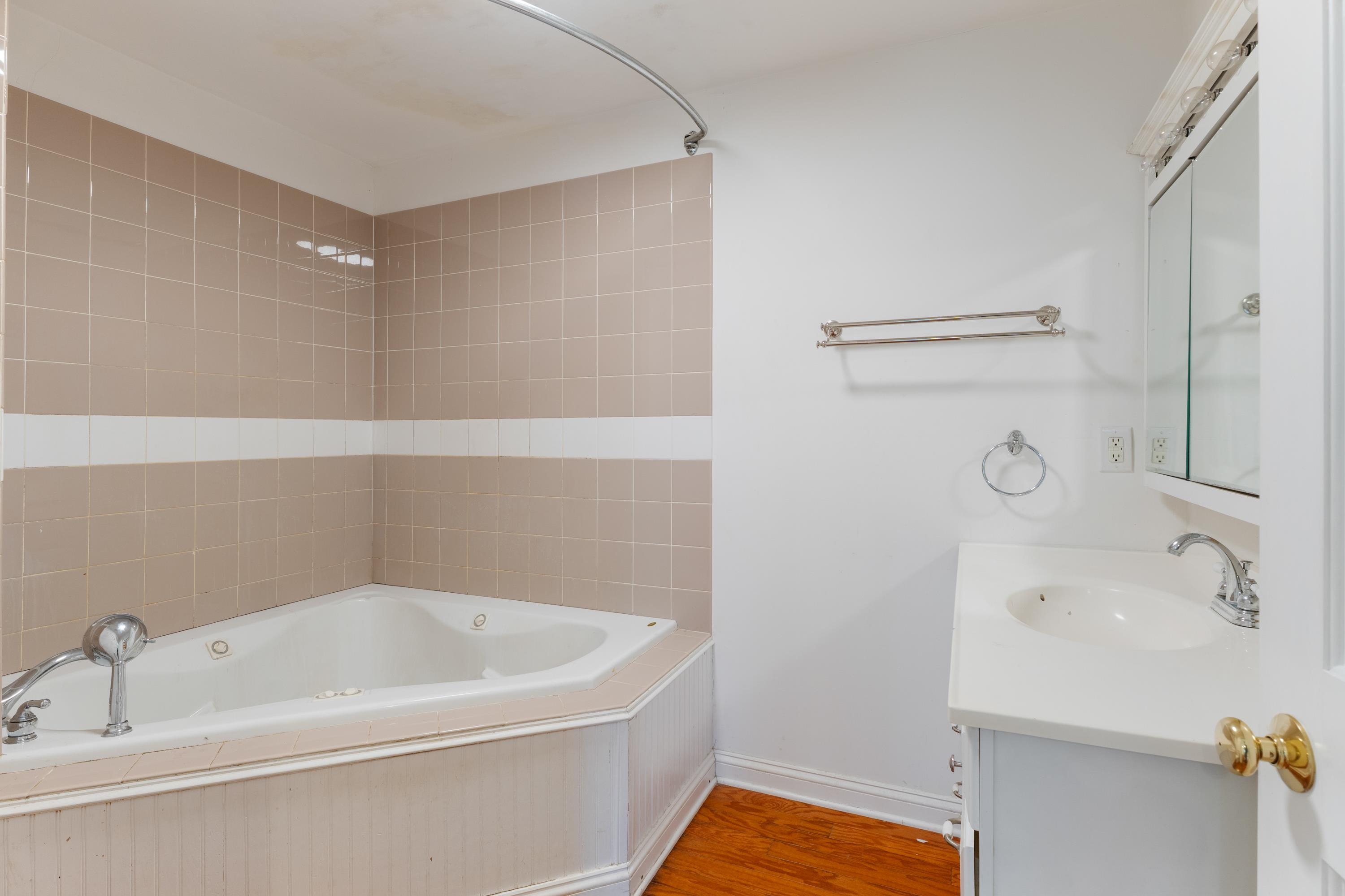 1261 Blue Ridge Avenue Crozet, VA 22932 - Photo 18 of 25 a white bath tub sitting next to a white sink and vanity