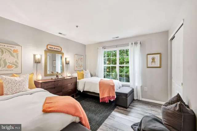 a bed room with two beds and a window