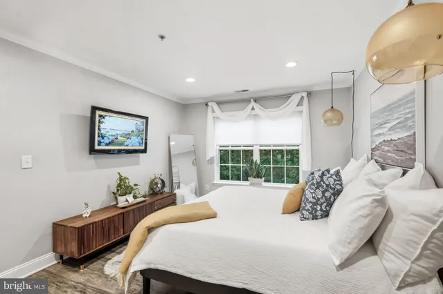 a bed room with a bed mirror and a window