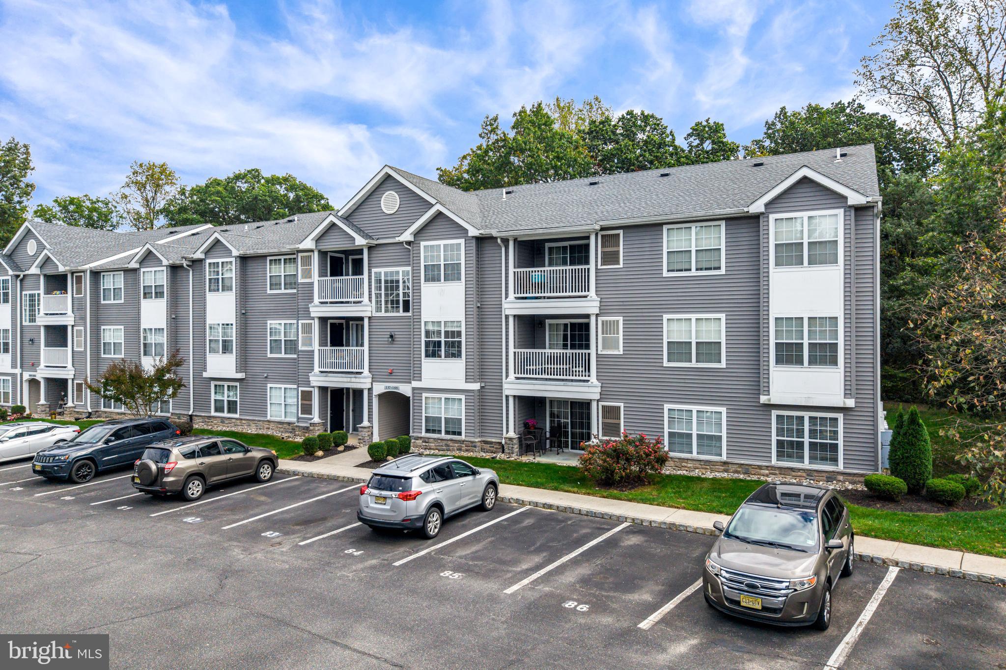 144 Natalie Road Delran, NJ 08075 - Photo 34 of 43 a front view of a house with a garden and parking space