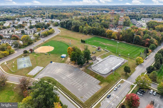 an aerial view of a residential houses with outdoor space and a lake view