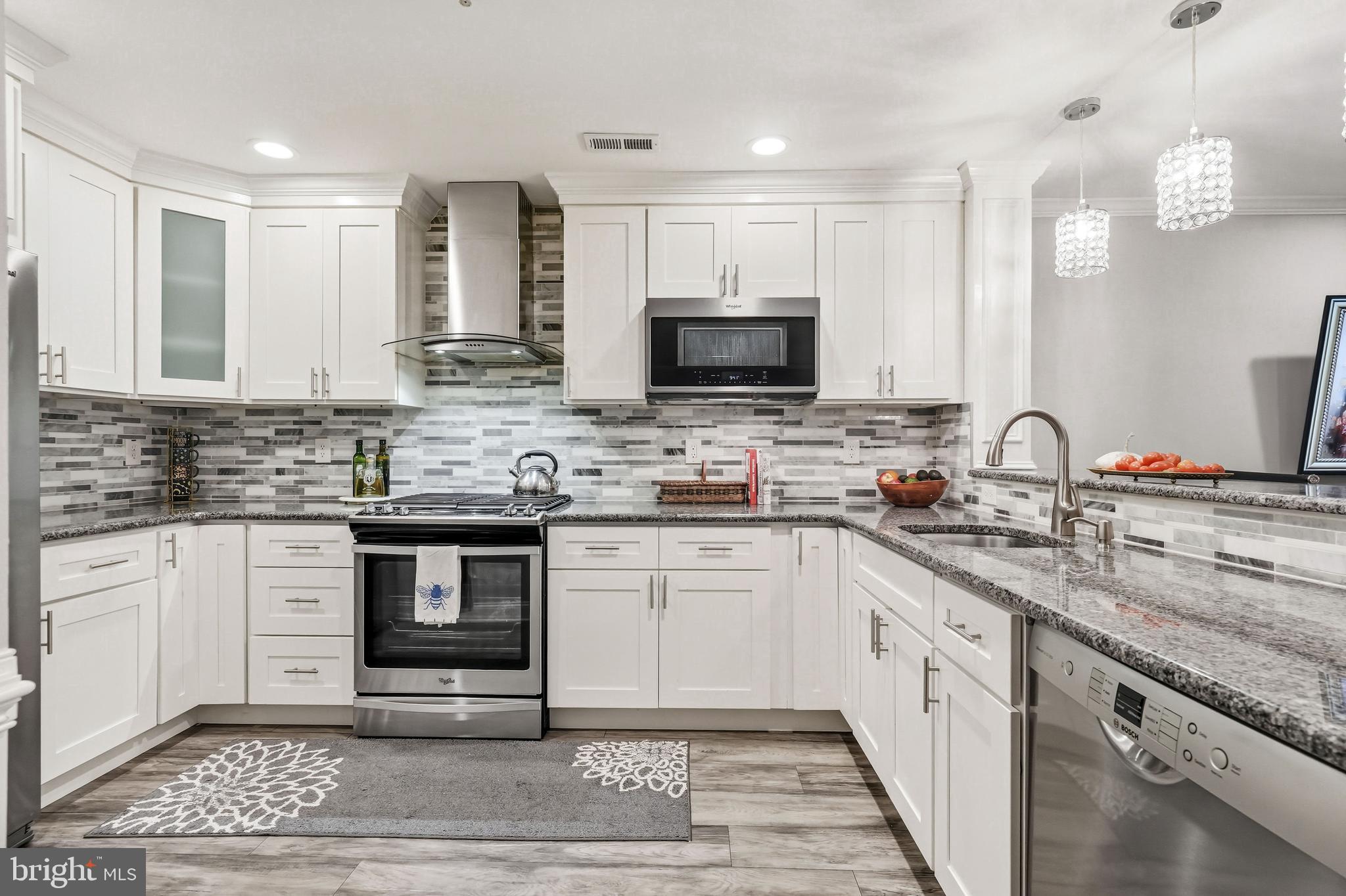 144 Natalie Road Delran, NJ 08075 - Photo 10 of 43 a kitchen with granite countertop a sink appliances and cabinets