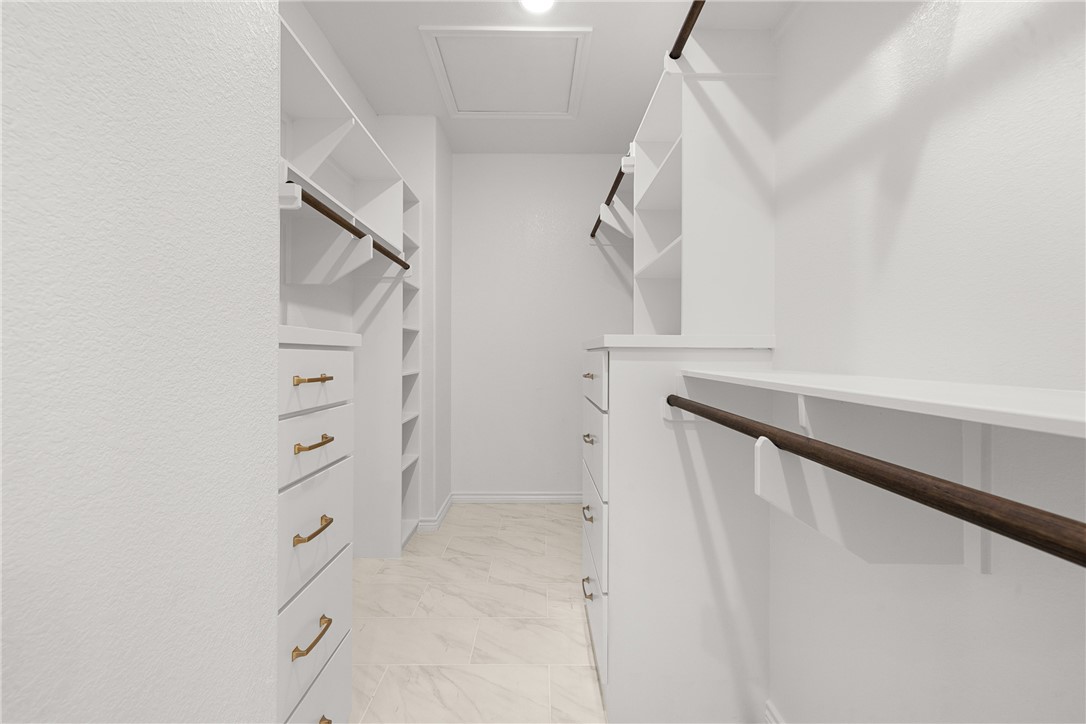 6512 Agave Court Bryan, TX 77808 - Photo 33 of 42 Walk in closet with attic access and light marble finish floors