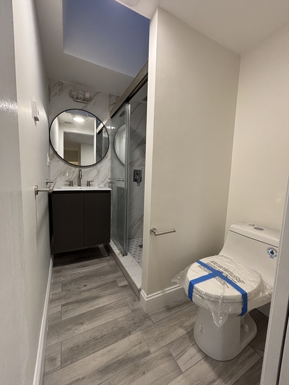 4 Appleton Street, Unit D Quincy, MA 02171 - Photo 9 of 12 a bathroom with a sink and a mirror
