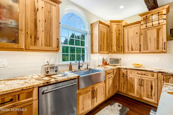 a kitchen with stainless steel appliances granite countertop a stove and a wooden cabinets