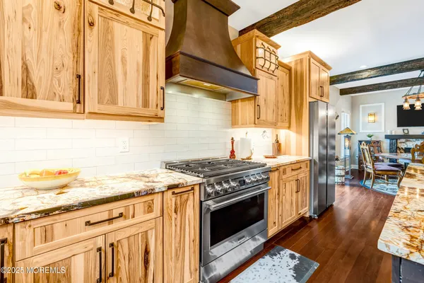 a dining room with furniture a flat screen tv and wooden floor