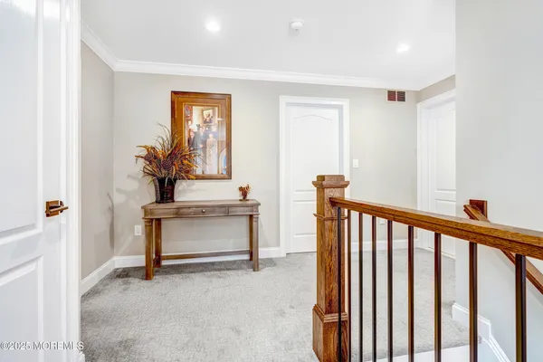 a bedroom with a large bed a chandelier and a flat tv screen