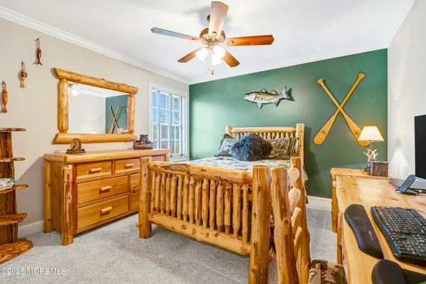 a spacious bedroom with a bed and ceiling fan