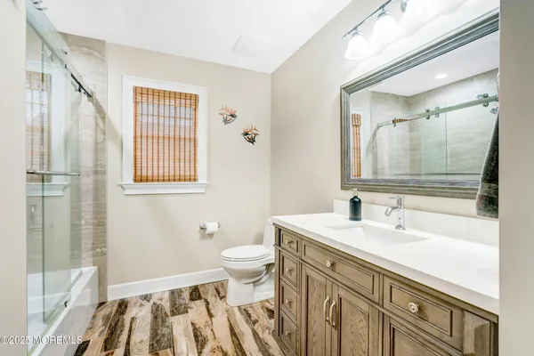 a white house with a bathtub and a ceiling fan