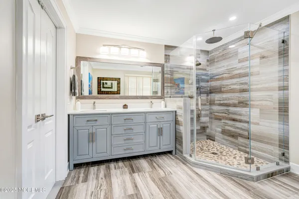 a bathroom with a sink a toilet and shower