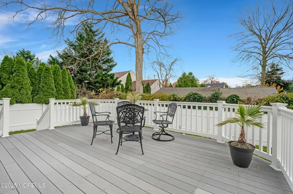 a front view of a house with a yard and potted plants