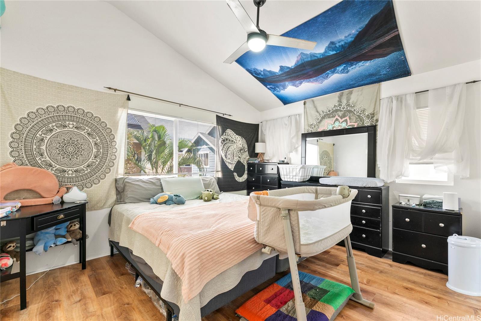 87-1962 Pakeke Street, Unit A Waianae, HI 96792 - Photo 11 of 25 a bedroom with a bed and a chandelier