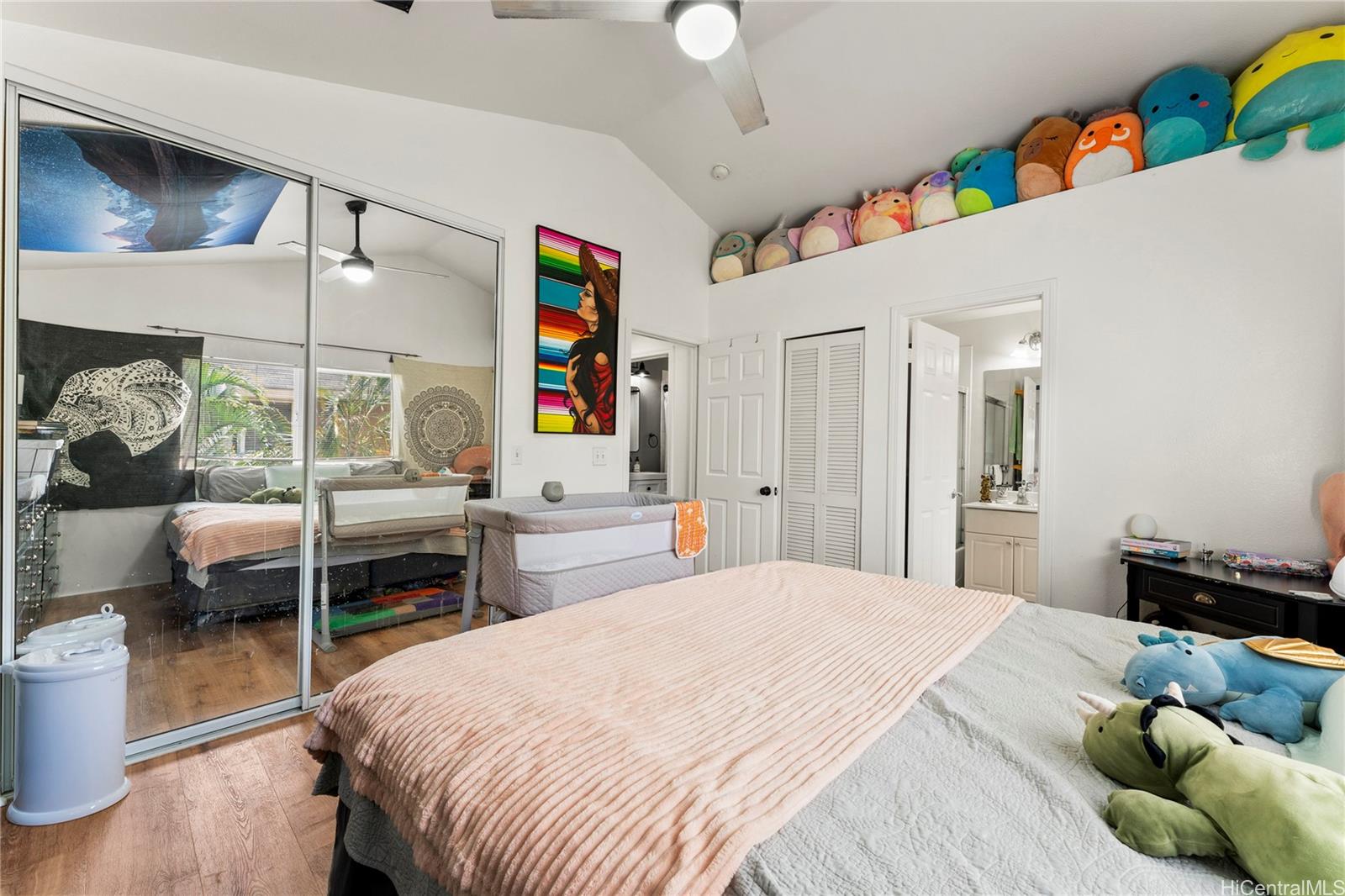 87-1962 Pakeke Street, Unit A Waianae, HI 96792 - Photo 12 of 25 a bedroom with a bed and wooden floor