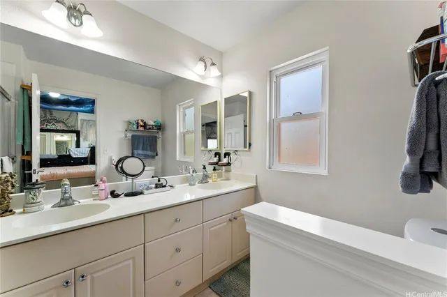 a bathroom with a double vanity sink and a mirror