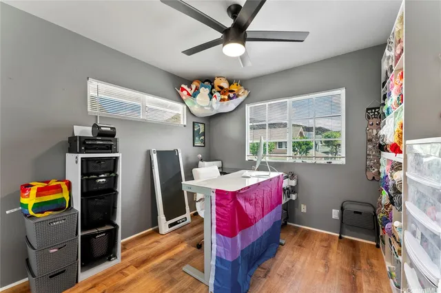 a living room with furniture a flat screen tv and a window