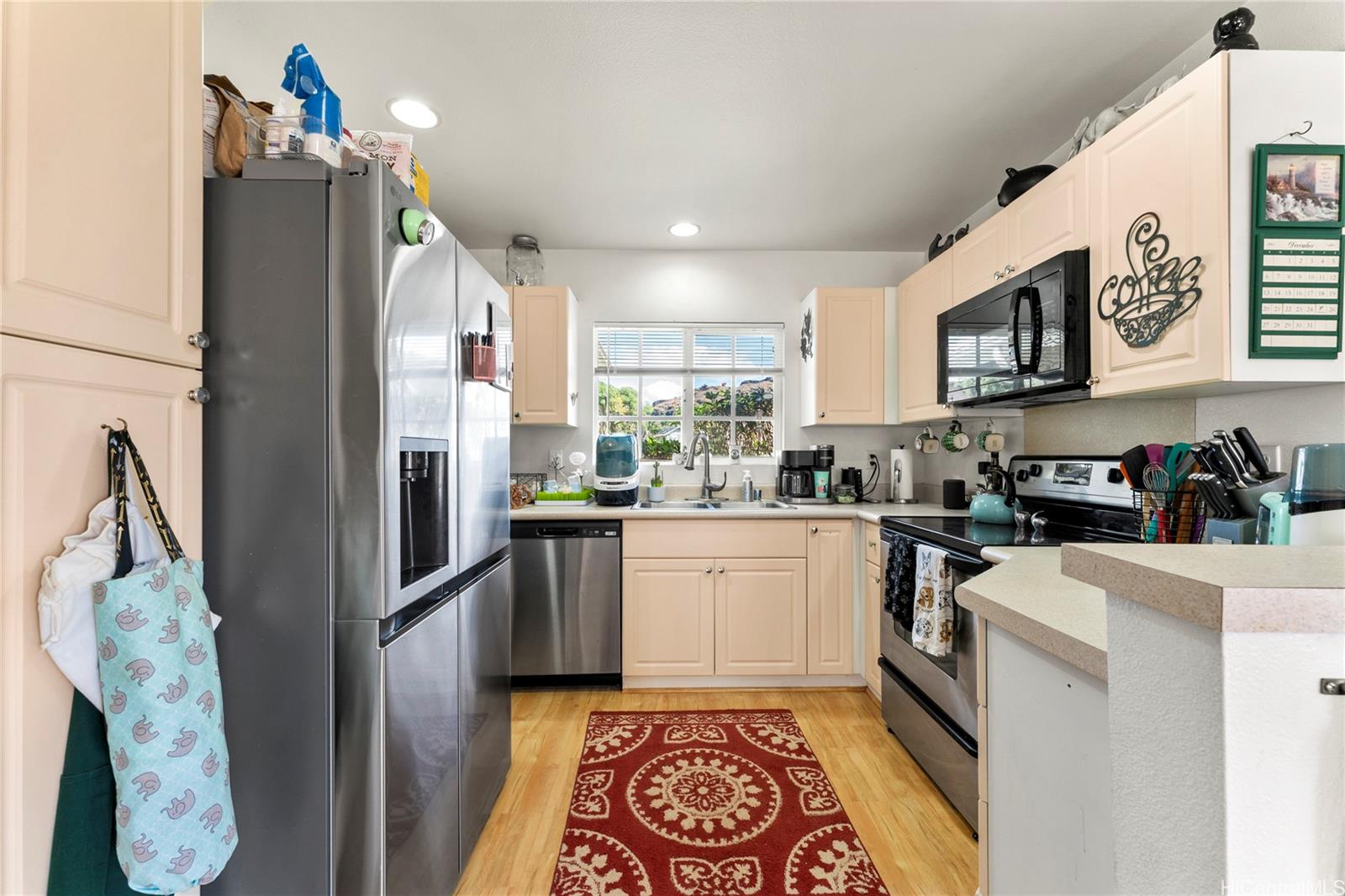 87-1962 Pakeke Street, Unit A Waianae, HI 96792 - Photo 7 of 25 a kitchen with stainless steel appliances granite countertop a refrigerator a stove and a sink