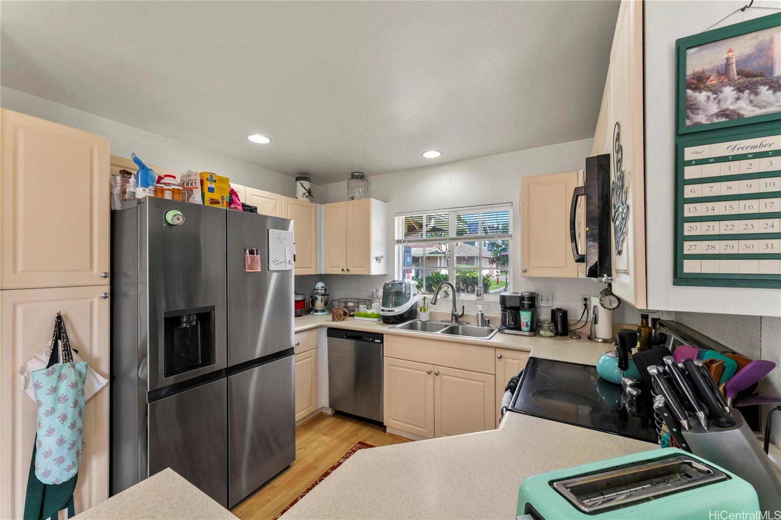 87-1962 Pakeke Street, Unit A Waianae, HI 96792 - Photo 8 of 25 a kitchen with a sink stainless steel appliances a refrigerator and cabinets