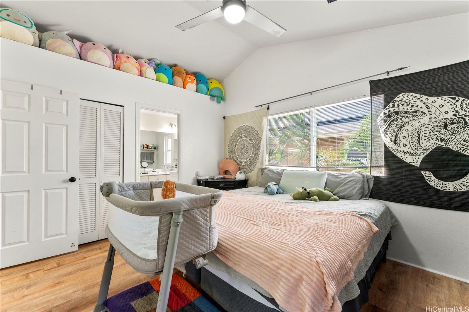 87-1962 Pakeke Street, Unit A Waianae, HI 96792 - Photo 10 of 25 a bedroom with a bed and a large window