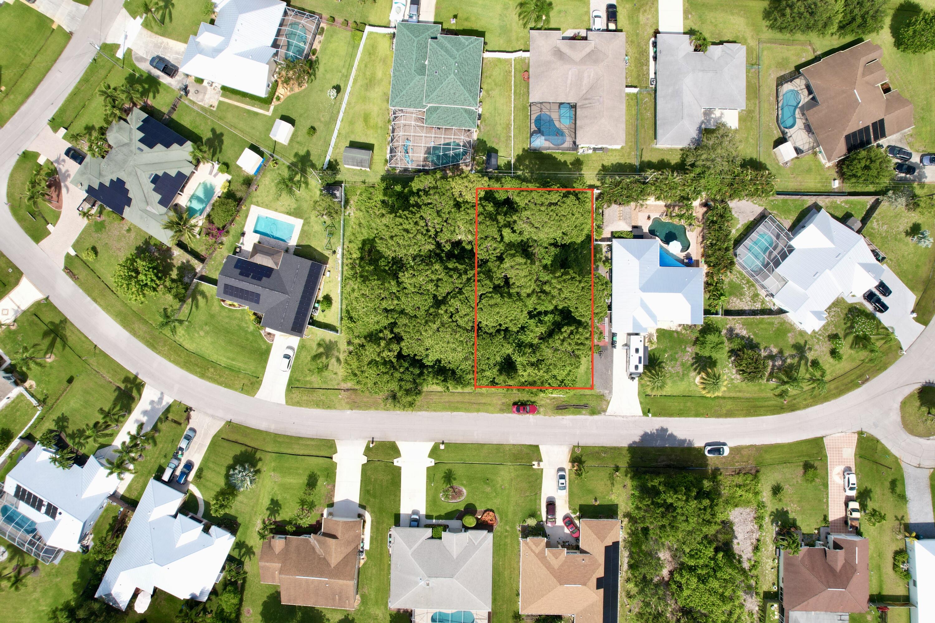 an aerial view of a residential apartment building with a yard and plants