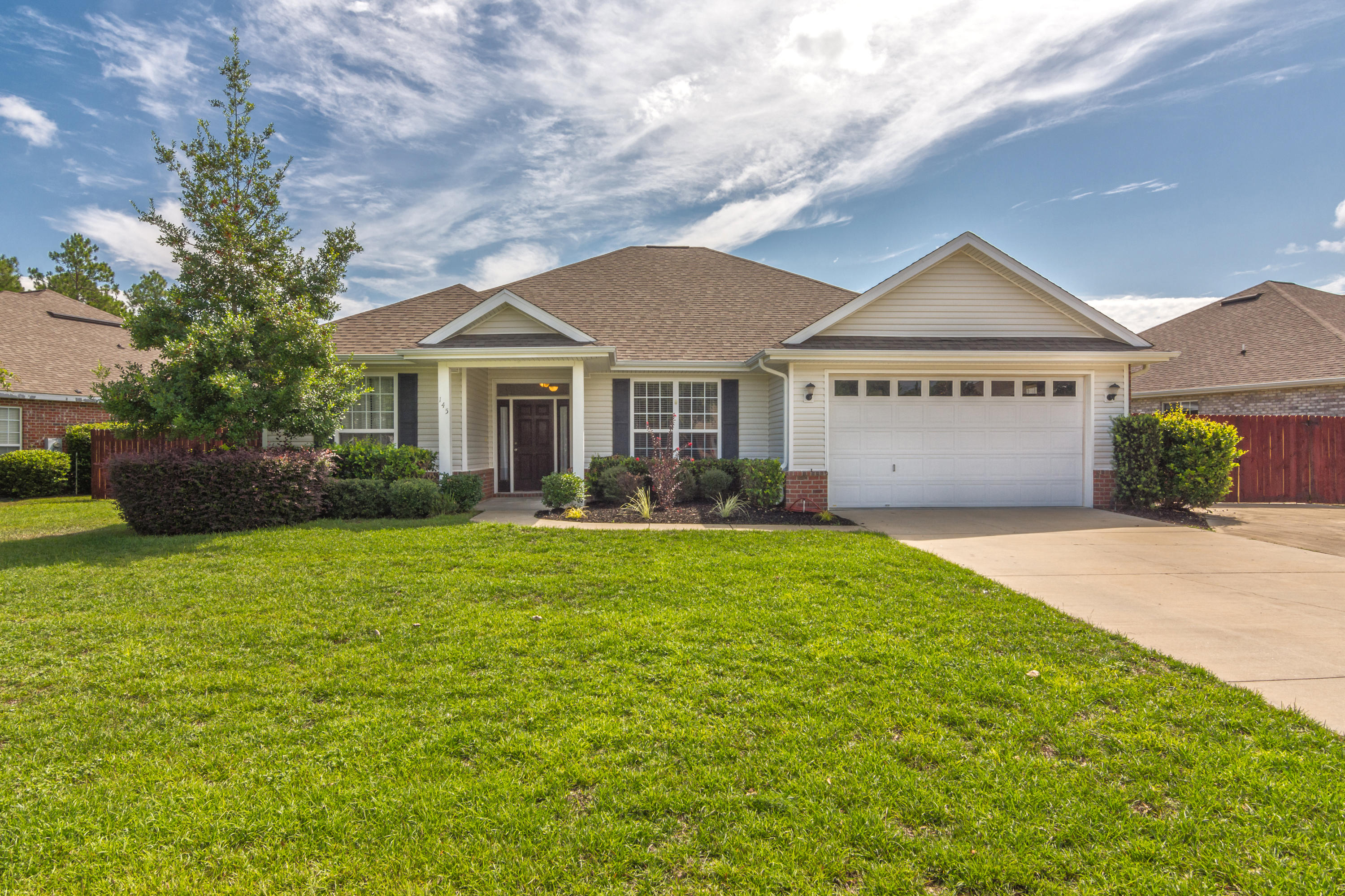 145 Alicia Drive Crestview, FL 32536 - Photo 1 of 32 a front view of a house with garden