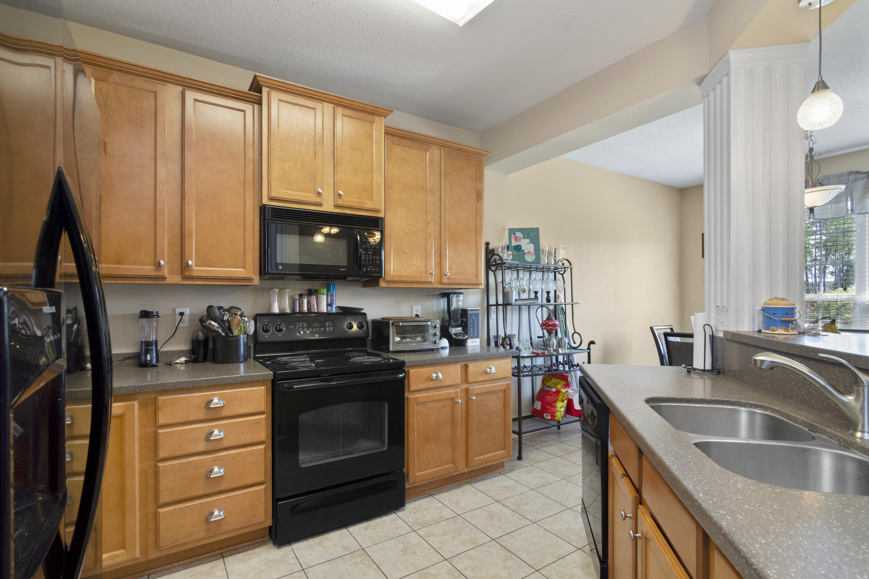 145 Alicia Drive Crestview, FL 32536 - Photo 12 of 32 a kitchen with a sink stove top oven and cabinets