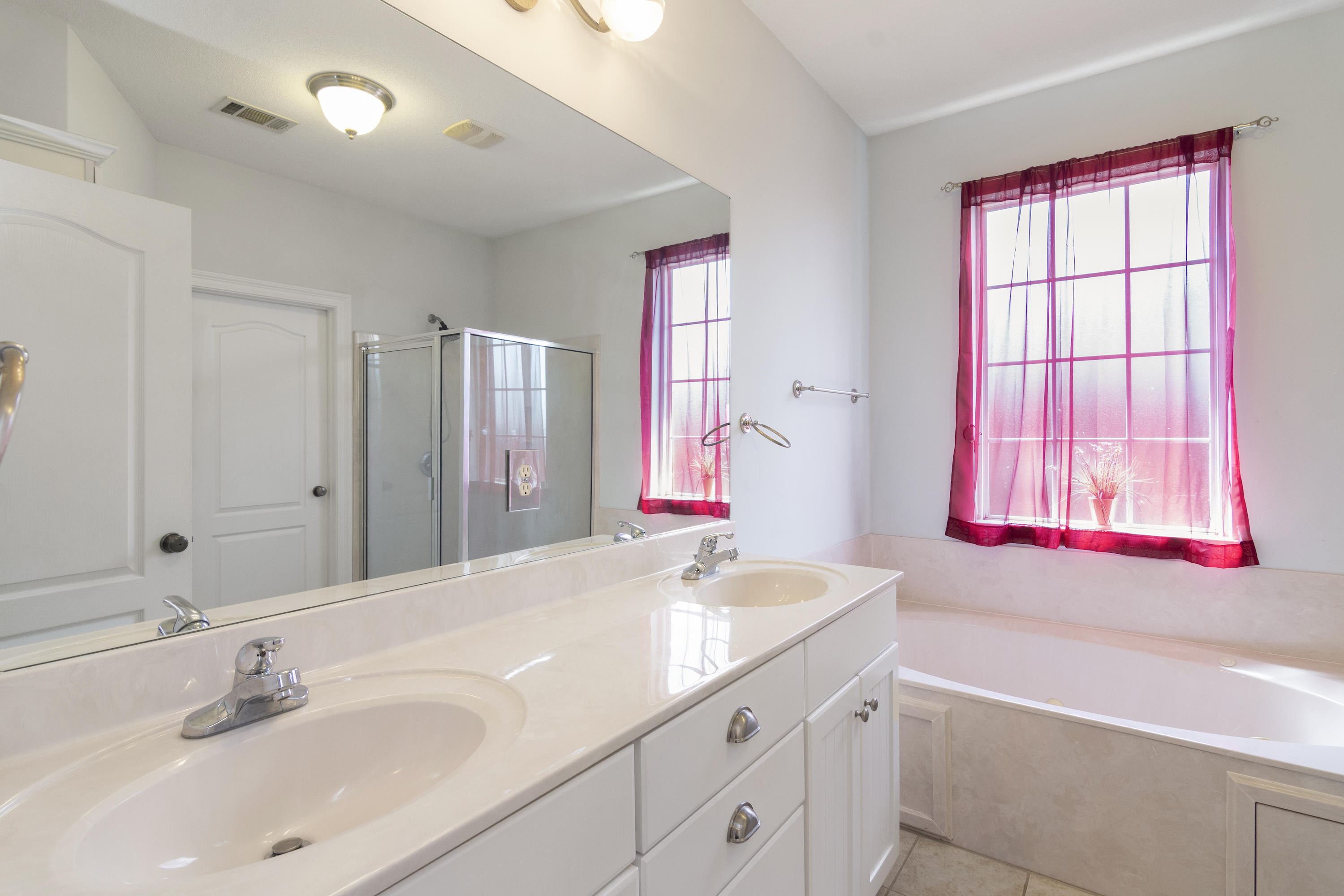 145 Alicia Drive Crestview, FL 32536 - Photo 19 of 32 a bathroom with a granite countertop sink and a large mirror