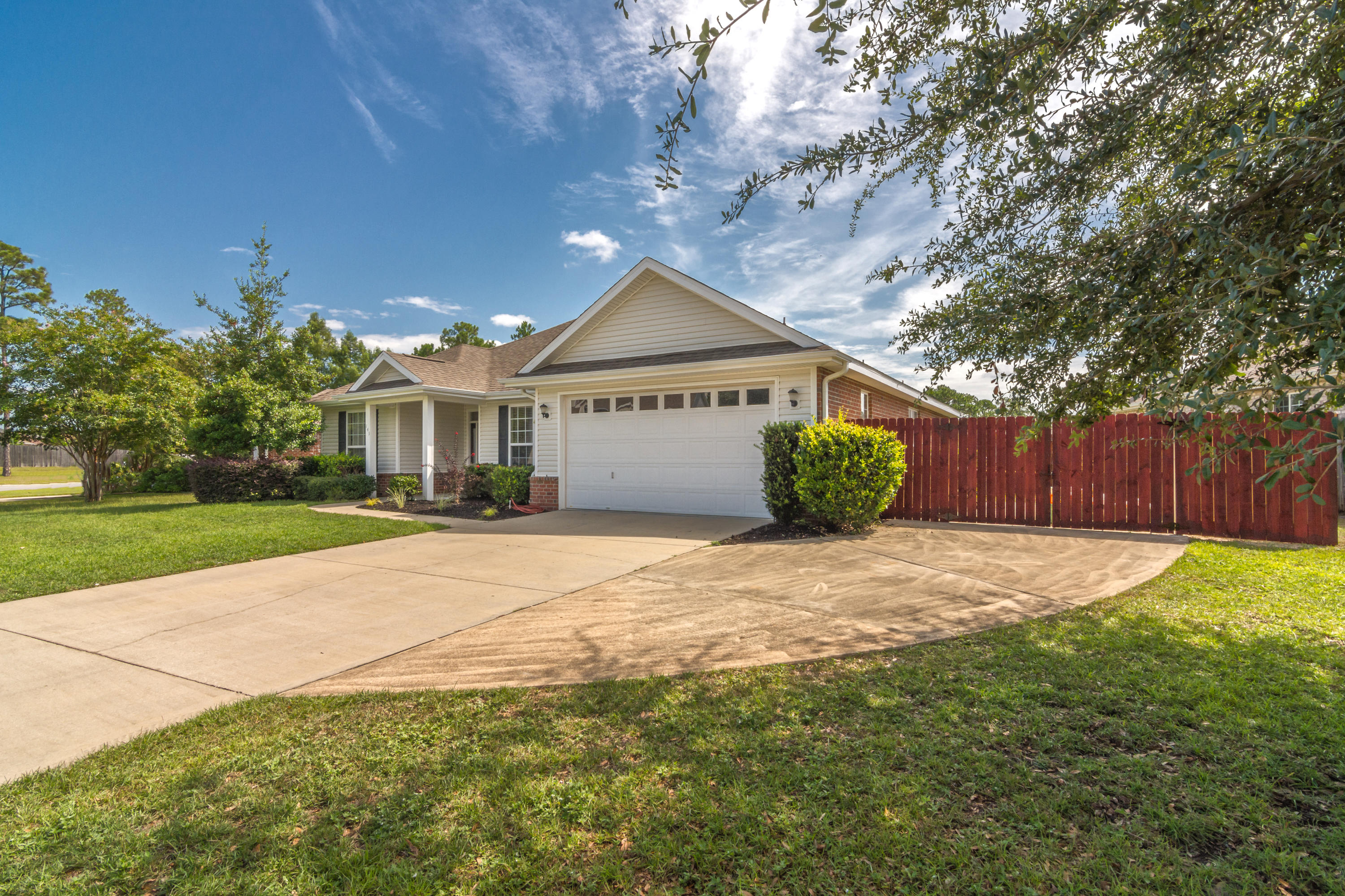 145 Alicia Drive Crestview, FL 32536 - Photo 2 of 32 a front view of a house with a yard and garage