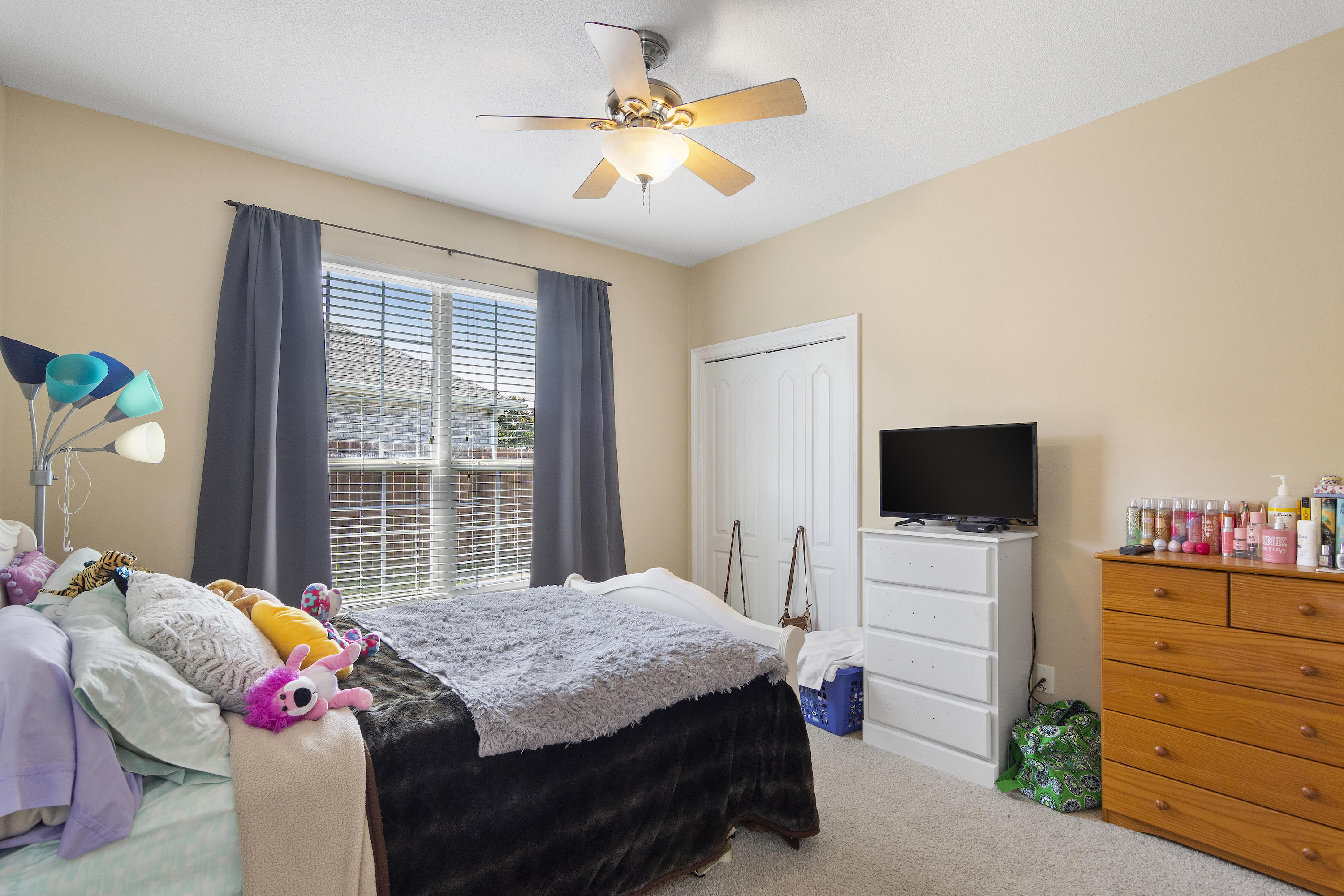 145 Alicia Drive Crestview, FL 32536 - Photo 22 of 32 a bedroom with a bed and a flat screen tv