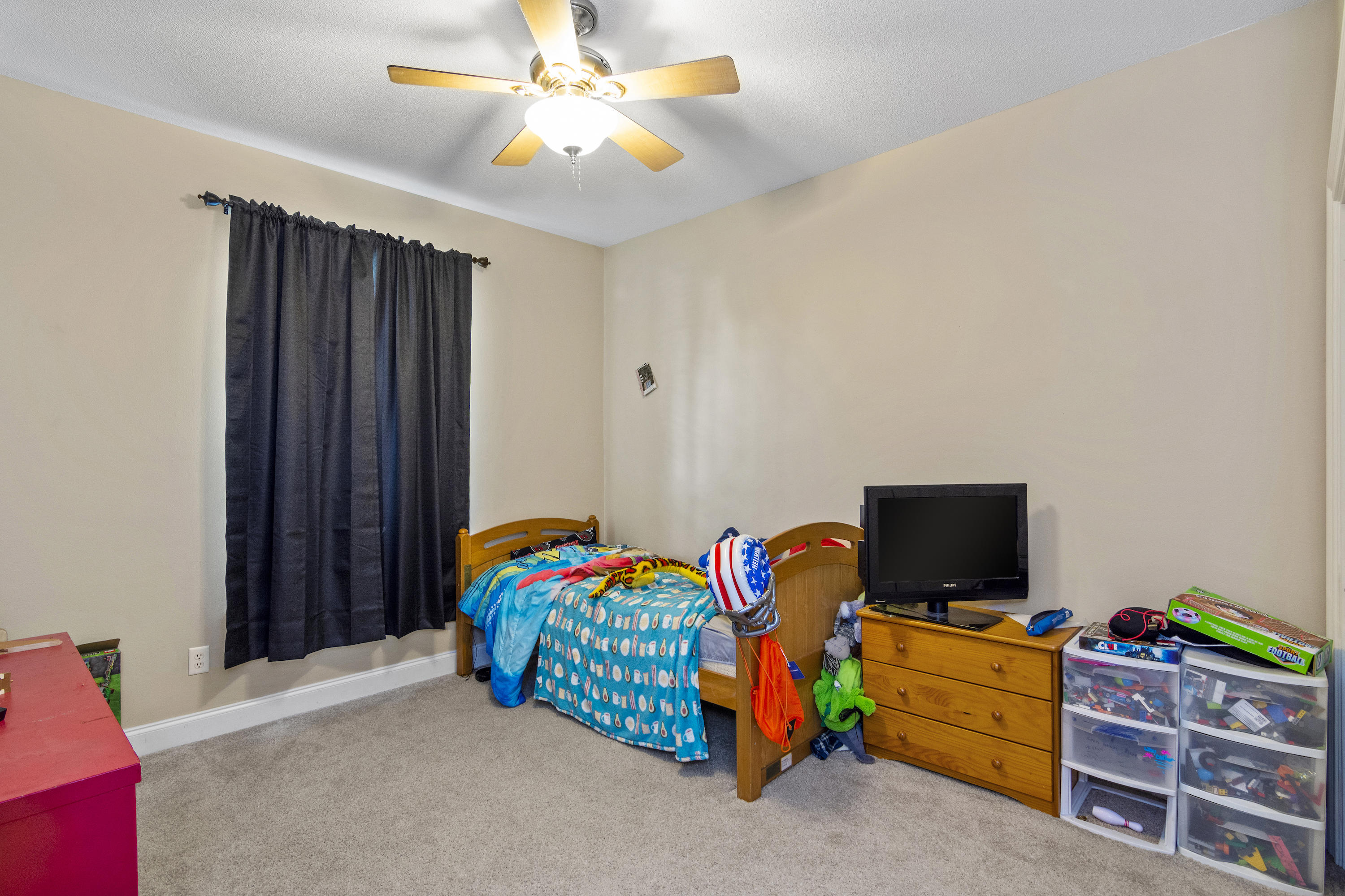 145 Alicia Drive Crestview, FL 32536 - Photo 23 of 32 a bedroom with furniture and a flat screen tv