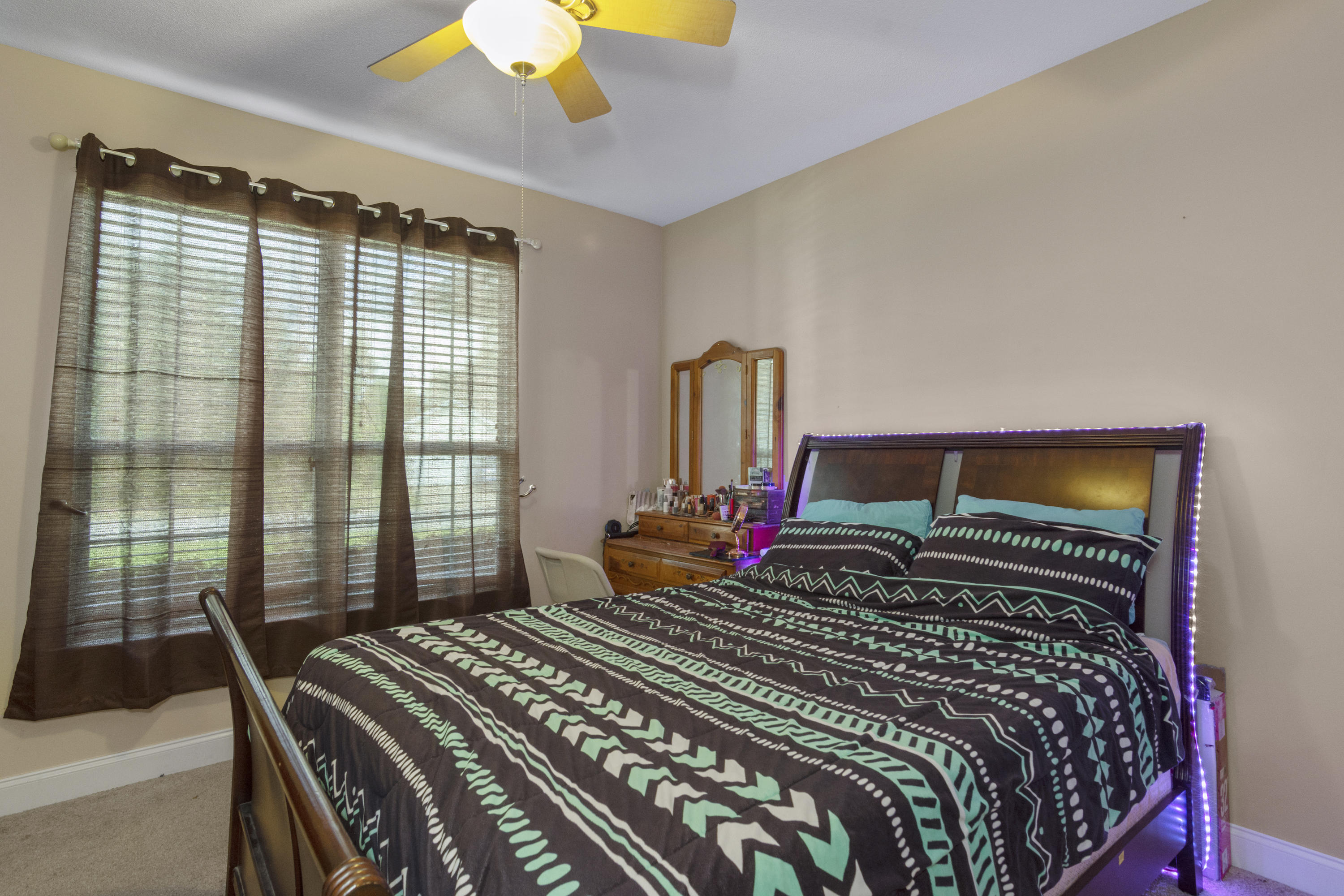145 Alicia Drive Crestview, FL 32536 - Photo 24 of 32 a bedroom with a bed next to a window