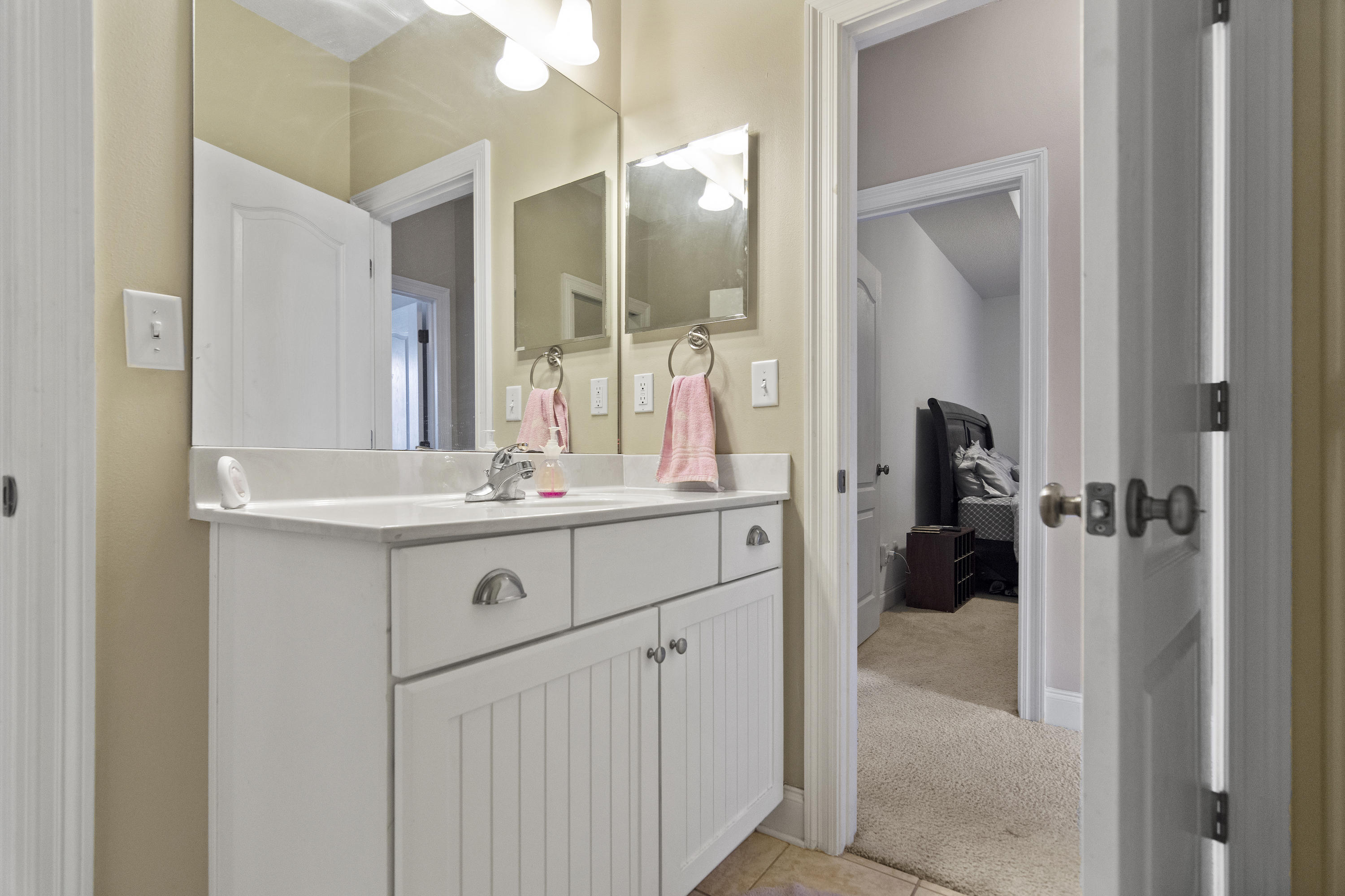 145 Alicia Drive Crestview, FL 32536 - Photo 25 of 32 a bathroom with a sink double vanity and a mirror