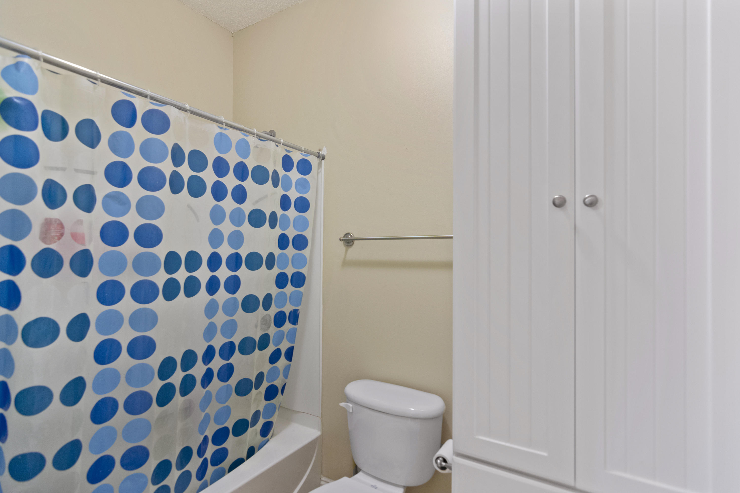 145 Alicia Drive Crestview, FL 32536 - Photo 26 of 32 a bathroom with a toilet and a shower curtain