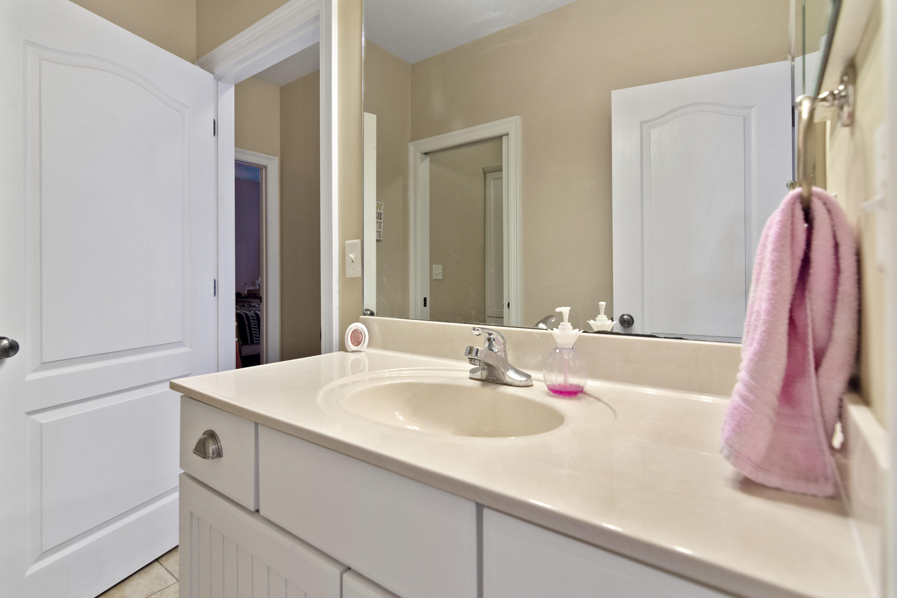 145 Alicia Drive Crestview, FL 32536 - Photo 27 of 32 a bathroom with a sink and a mirror