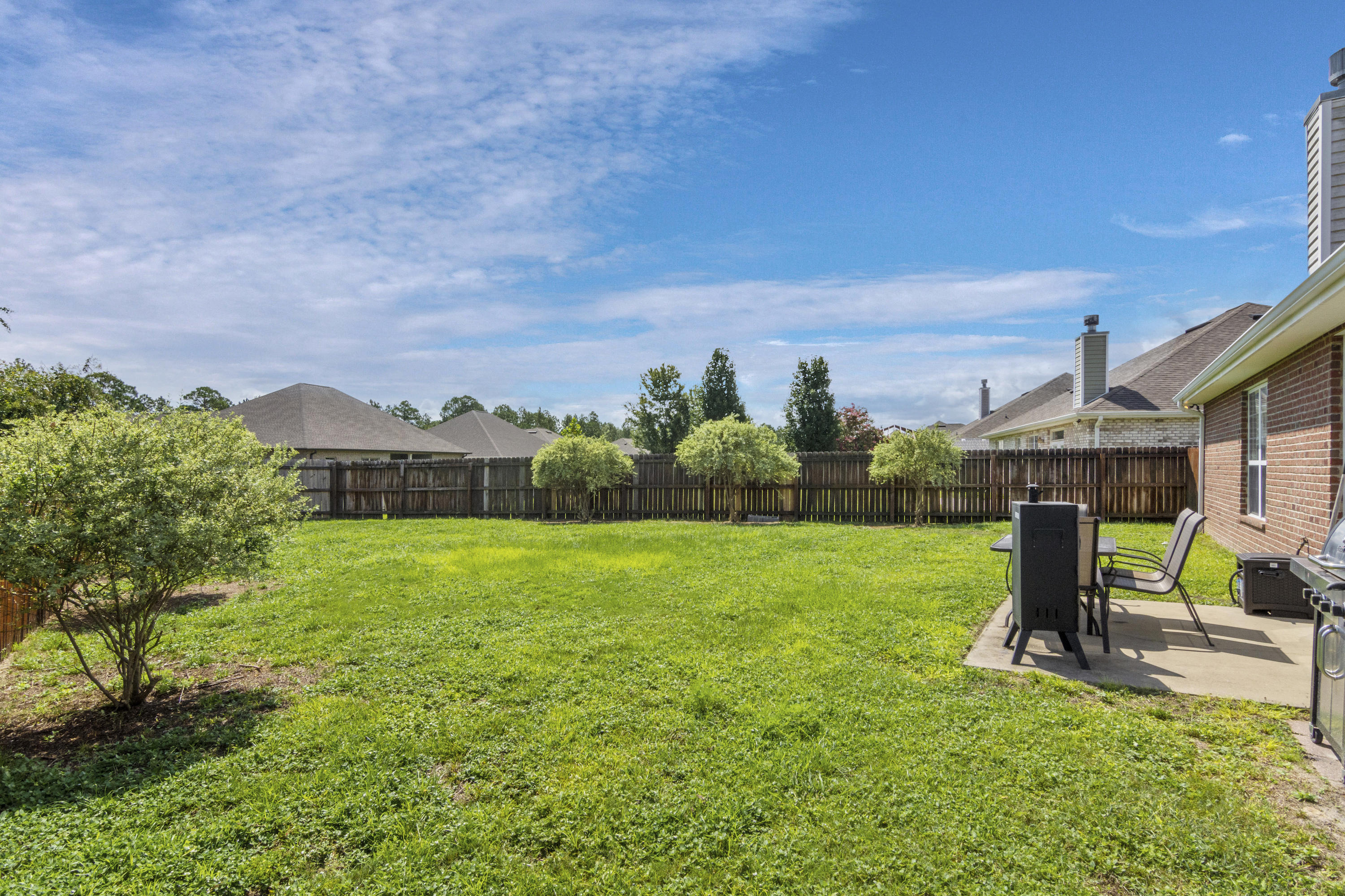 145 Alicia Drive Crestview, FL 32536 - Photo 29 of 32 a view of a big yard next to a house